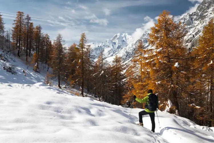 a man goes hiking alone in winter
