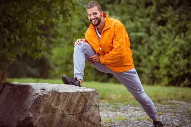 a man is stretching after a hike