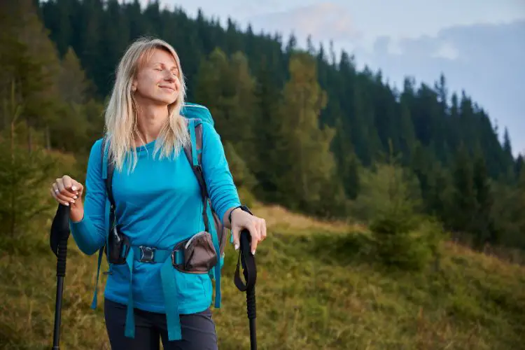 a woman is hiking and enjoys fresh air