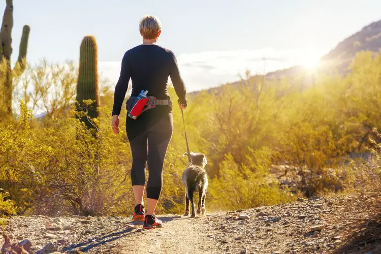 a woman takes her god for hiking