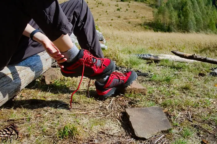 a woman takes of her hiking boots