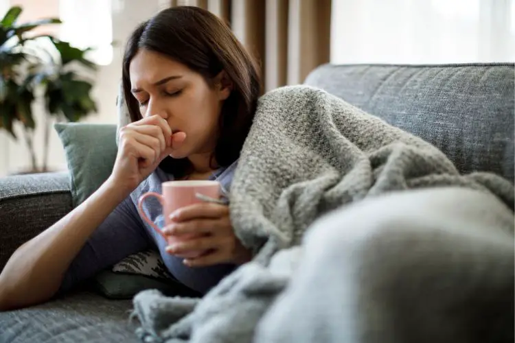 girl with a cold is coughing at her home