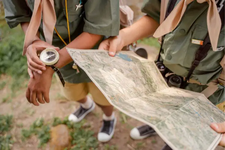 hikers are using a compass and map for navigating