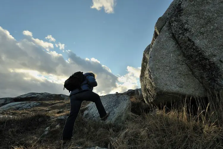 man is hiking on rough terrain