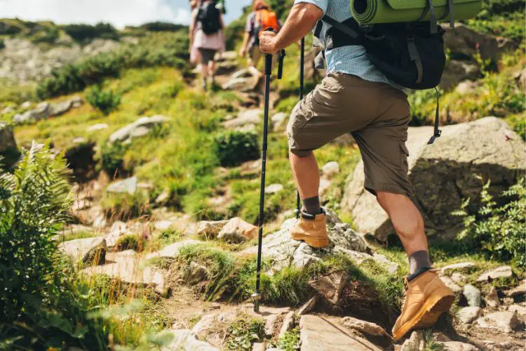 man is hiking uphill