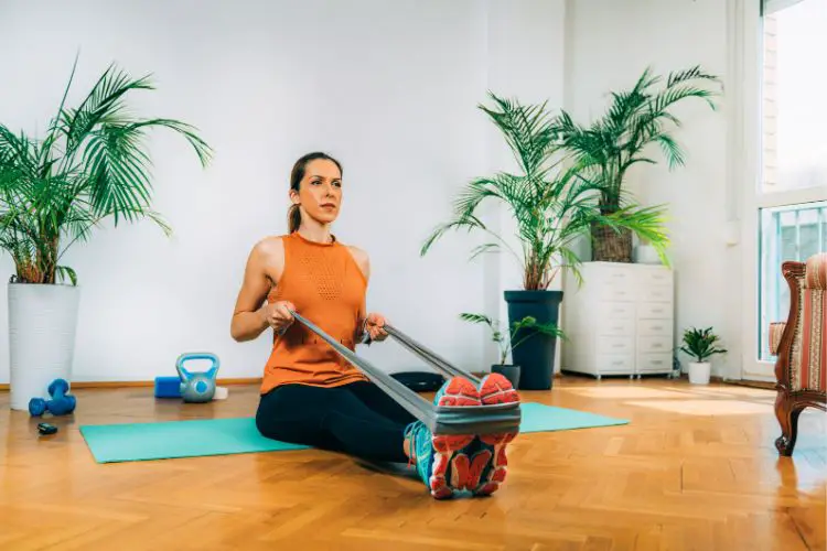 woman exercises strength training with elastic band