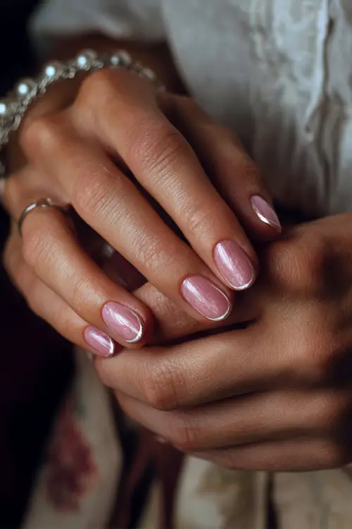 Acrylic bridal nails close-up, ballerina-shaped with blush base and chrome French tips, bride’s hand gently adjusting her bracelet