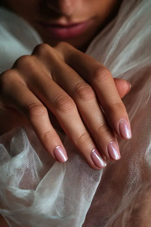 Bridal fingers resting gently on veil fabric, short ballerina nails in pale pink with diagonal silver chrome tips, soft dreamy lighting