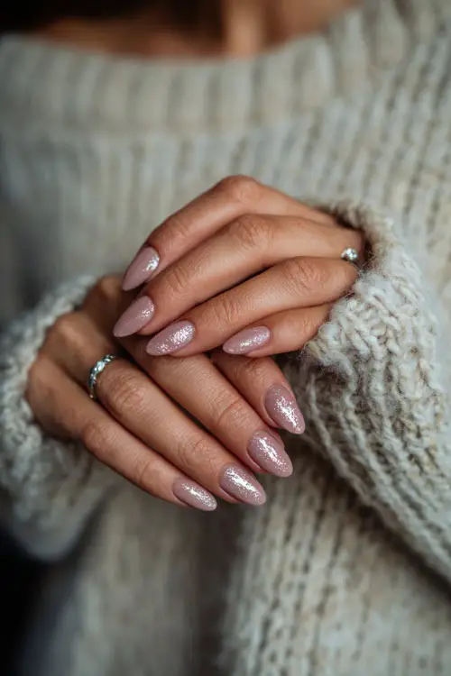 Bride holding a silver hairpin, long almond acrylic nails in ombré blush pink with silver leaf flakes on accent nails