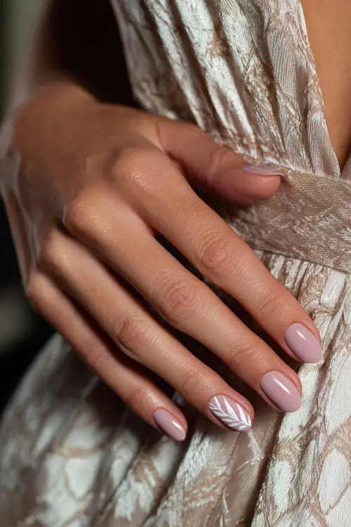 Bridesmaid’s hand against chiffon dress folds, short oval nails painted in soft rose beige with minimalist white leaf detailing on the ring finger