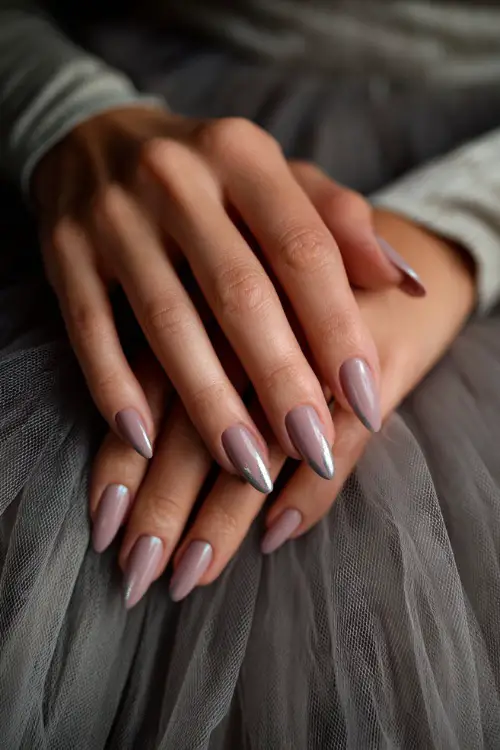 Hand brushing tulle gown, almond nails in soft gray-pink with silver chrome arcs along the center of each nail, modern elegant vibe 