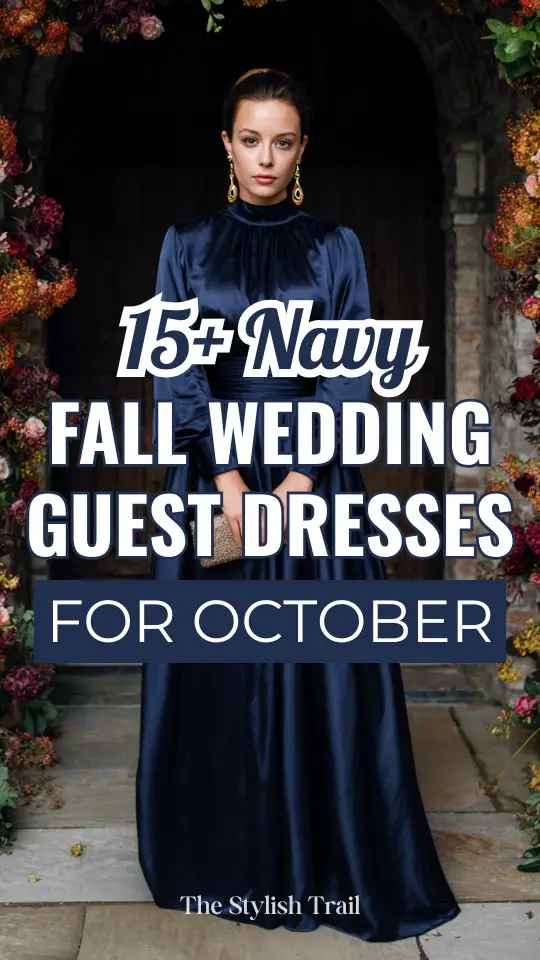 a woman wears a navy satin fall wedding guest dress with long sleeves and a full skirt for an October wedding
