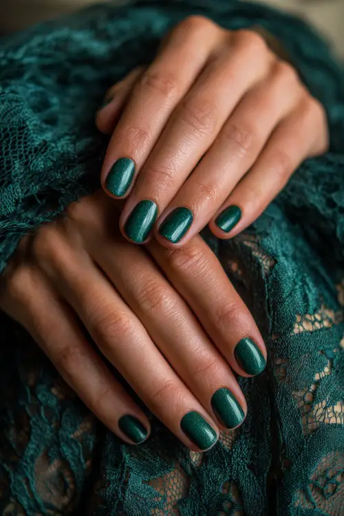 Elegant emerald green nails with metallic sheen, bridesmaid’s hands resting on a lace shawl
