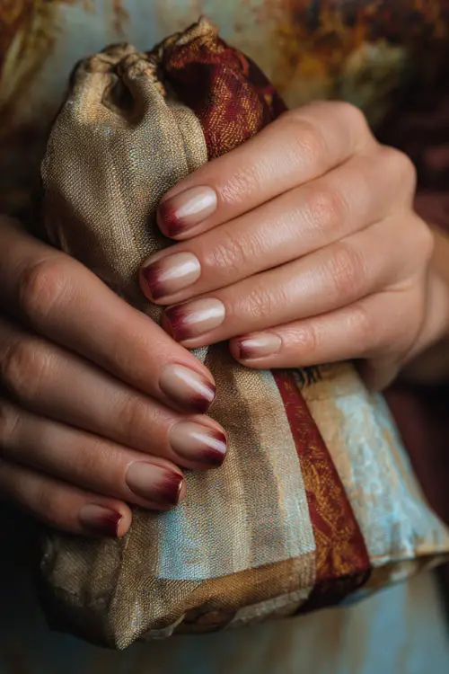 Ombré nails blending beige and burnt sienna, guest holding a wedding favor bag