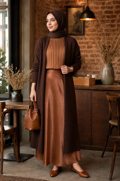 Brown Pleated Top and Long Cardigan Outfit Modest brown outfit featuring a pleated high-neck top, long ribbed cardigan, leather-look skirt, hijab, handbag, and matching flats.