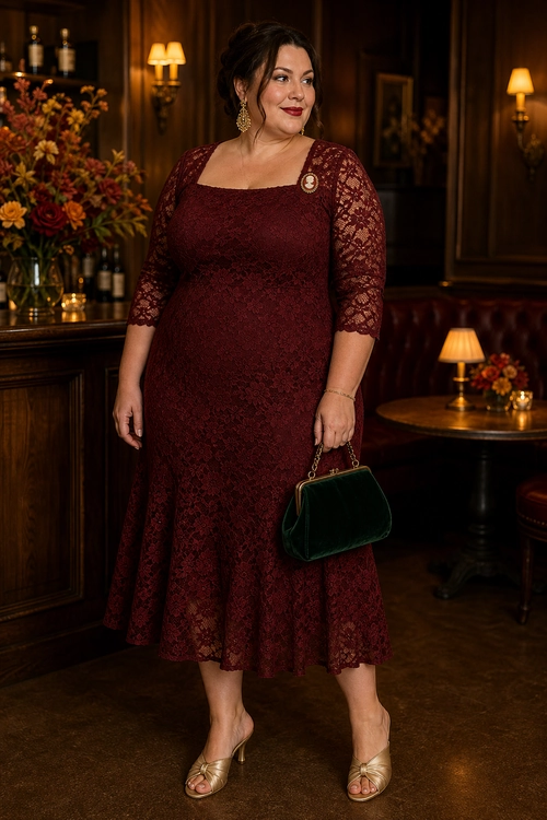 A burgundy lace midi dress with three-quarter sleeves is styled with gold heeled sandals and a dark green velvet handbag.