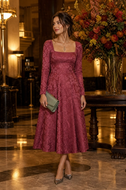 Burgundy Lace Midi Dress A woman wears a burgundy long-sleeve lace midi dress with pointed-toe pumps and carries a muted green clutch.