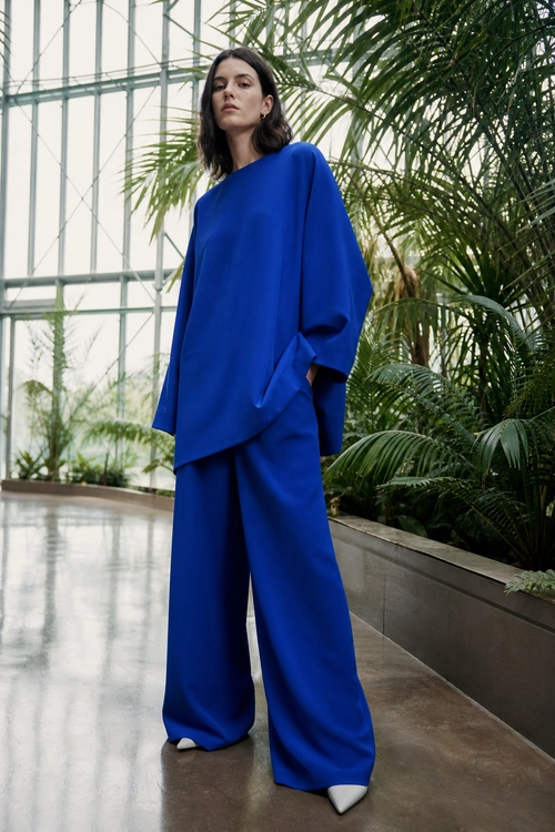Cobalt Blue Wide-Leg Suiting A cobalt blue oversized long-sleeve top and wide-leg trousers styled with white pointed-toe shoes.