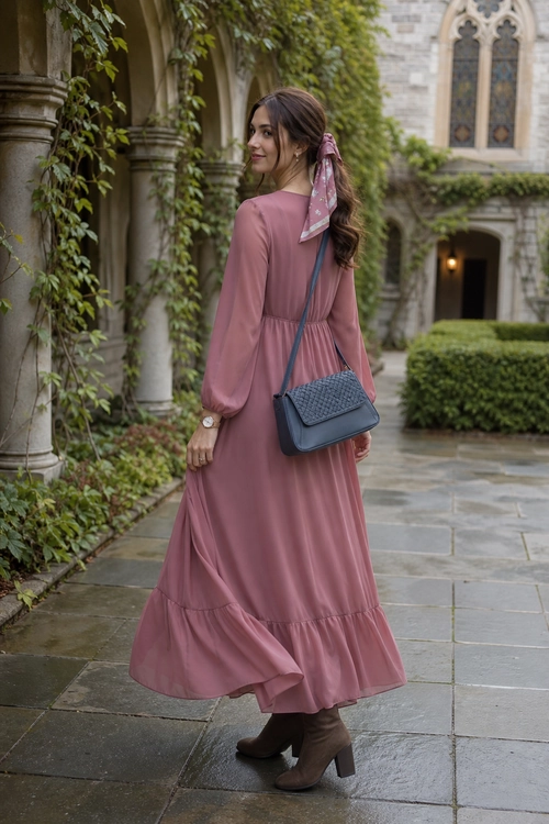 Dusty Rose Maxi Dress Outfit A dusty rose long-sleeve maxi dress with a ruffled hem is styled with a patterned hair scarf, dark blue crossbody bag, and brown ankle boots.