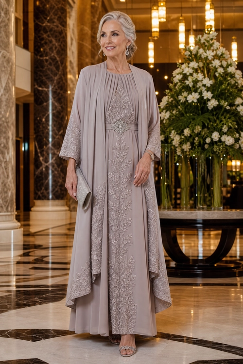 Embellished Taupe Evening Ensemble A woman wears a long taupe embellished gown with a matching draped cape, clutch, earrings, and strappy sandals.