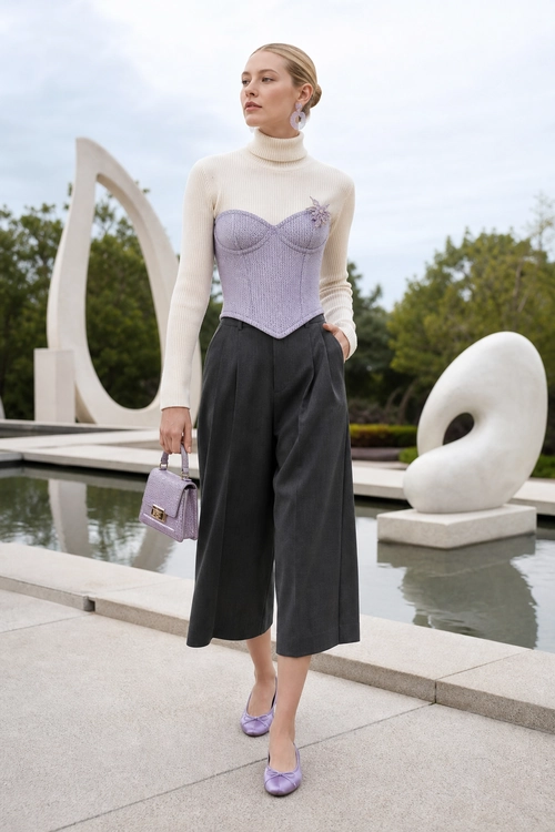 Lilac Corset and Wide-Leg Trousers Outfit A cream turtleneck layered with a lilac corset-style top, charcoal wide-leg cropped trousers, a lilac handbag, and matching ballet flats.