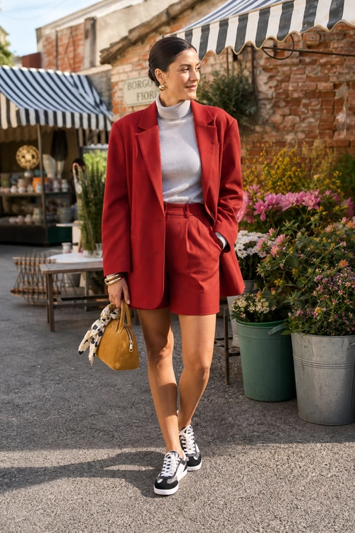 Red Blazer and Shorts Outfit A woman wears a red blazer with matching tailored shorts, a light gray turtleneck, black-and-white sneakers, and a mustard handbag.