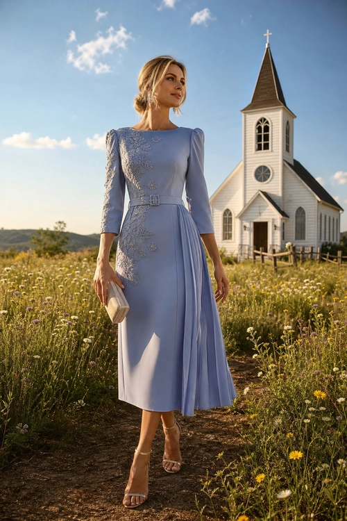 A woman wears a light lavender long-sleeve midi dress with floral lace detailing, a belted waist, beige strappy heels, and a cream clutch.