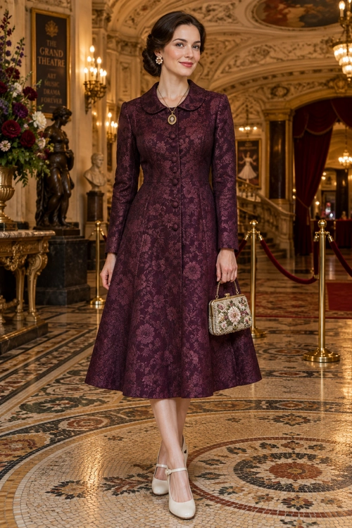 Burgundy Jacquard Midi Dress Woman wearing a long-sleeved burgundy floral jacquard midi dress with a small embellished handbag and cream Mary Jane heels.